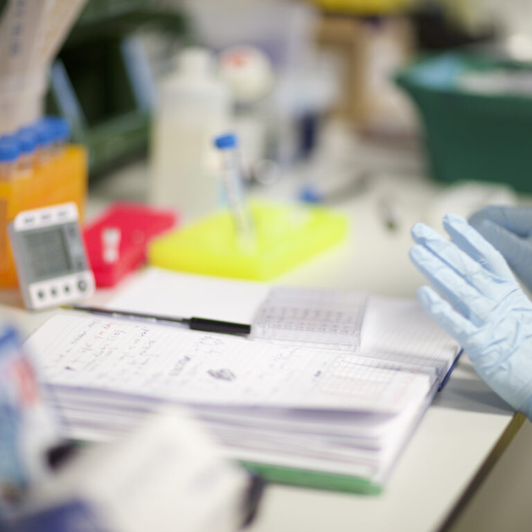 Person writing in a laboratory book