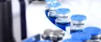 Glass bottles in production in the tray of an automatic liquid dispenser, a line for filling medicines against bacteria and viruses, antibiotics and vaccines