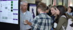 Academics and PhD students at the PGR showcase in front of academic posters within the OCRB
