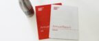 Two previous annual reports from 2019 and 2020/2021 on a table with an MCRC water bottle