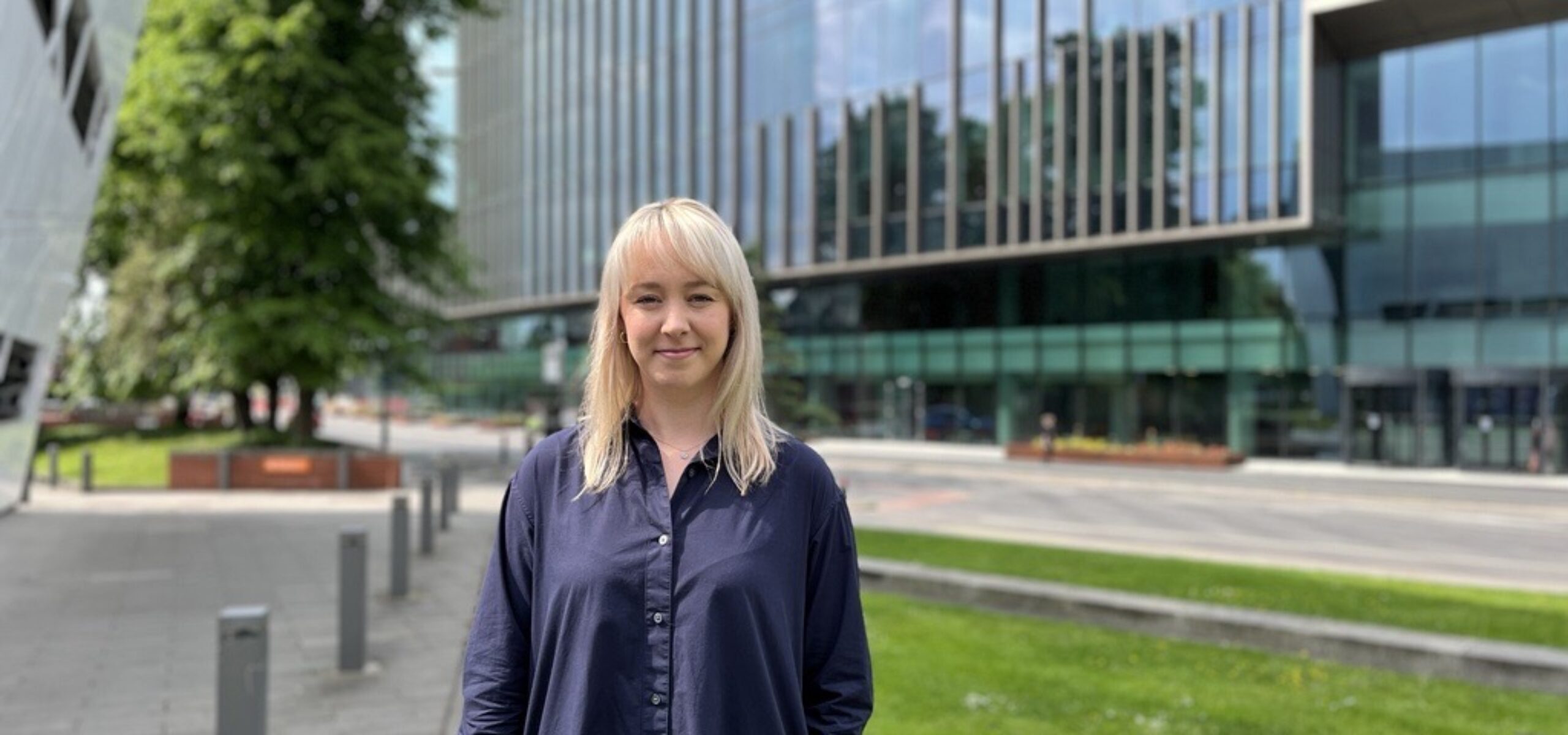 Laura Woodhouse headshot in front of the paterson building