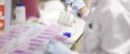 A scientist using a pipette in a laboratory