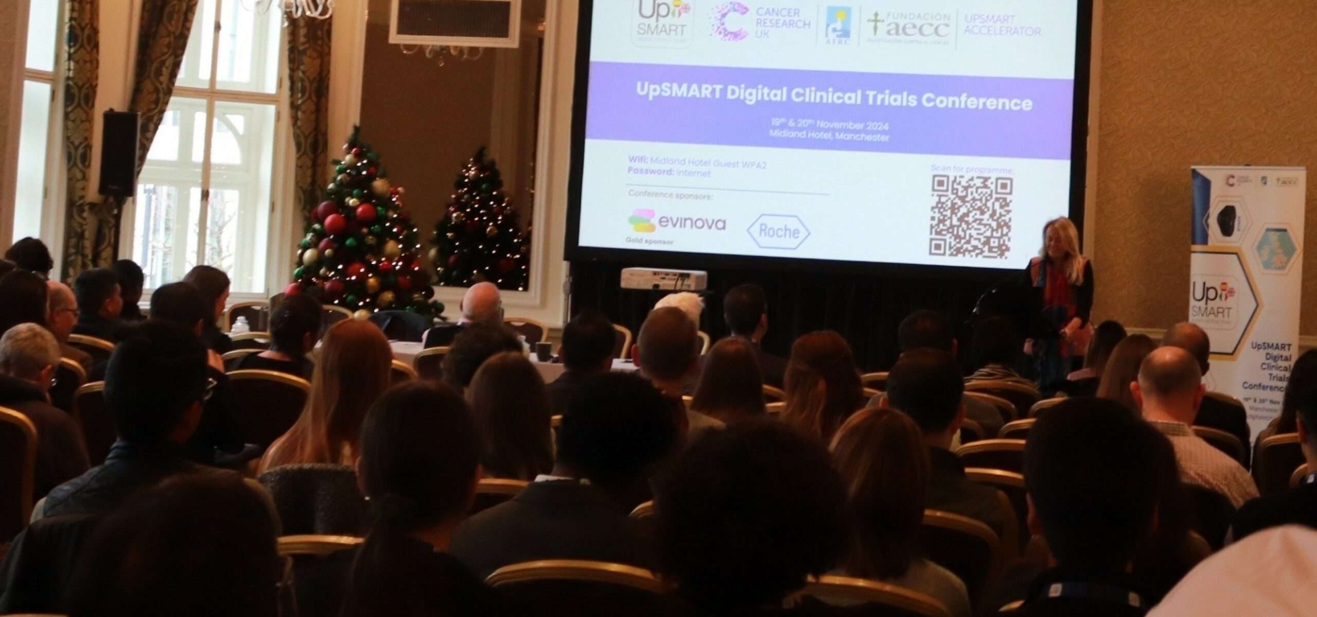 Prof Caroline Dive presenting at the UpSMART Accelerator Award conference in front of attendees