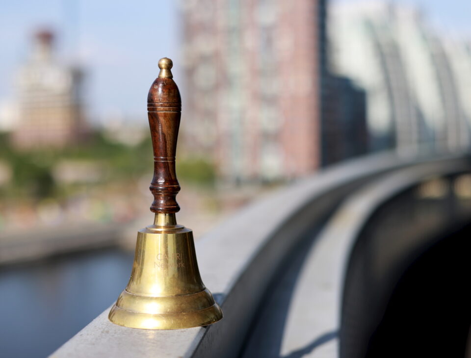 The Ca-PRI bell which is passed on to each host institution.