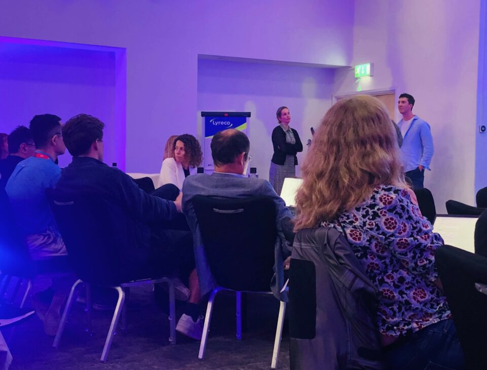 Audience members listening to a guest speaker present their research
