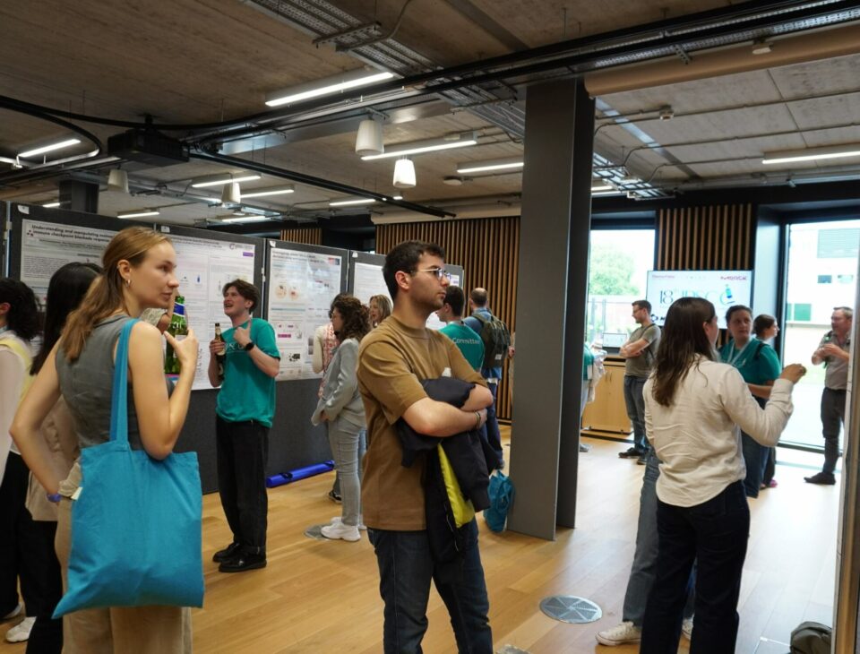 PhD students attending a breakout poster session