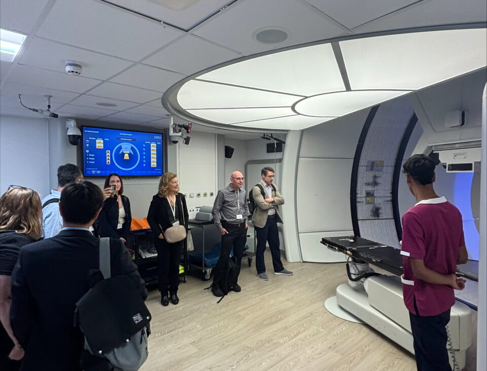Colleagues from the Princess Margaret Cancer Centre looking at cancer therapy equipment in The Christie