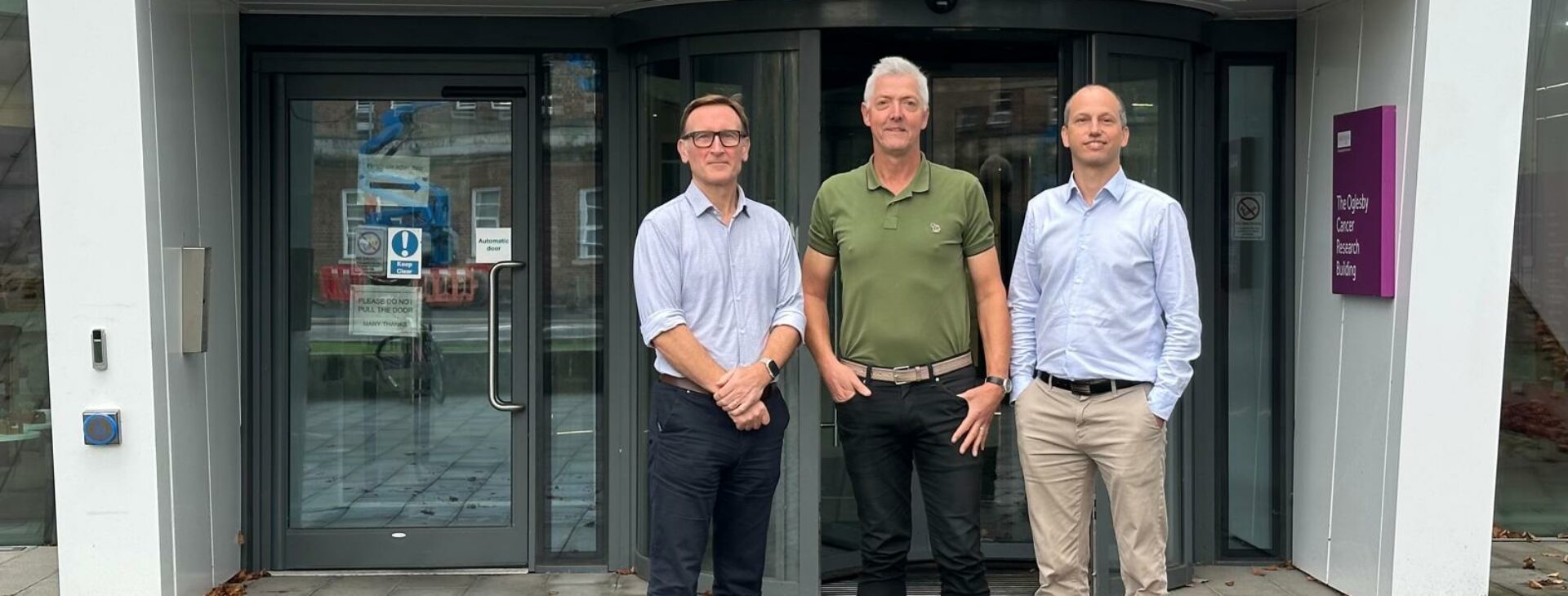 Sacha Howell, Rob Clarke, Bruno Simoes outside of the Manchester Cancer Research Centre