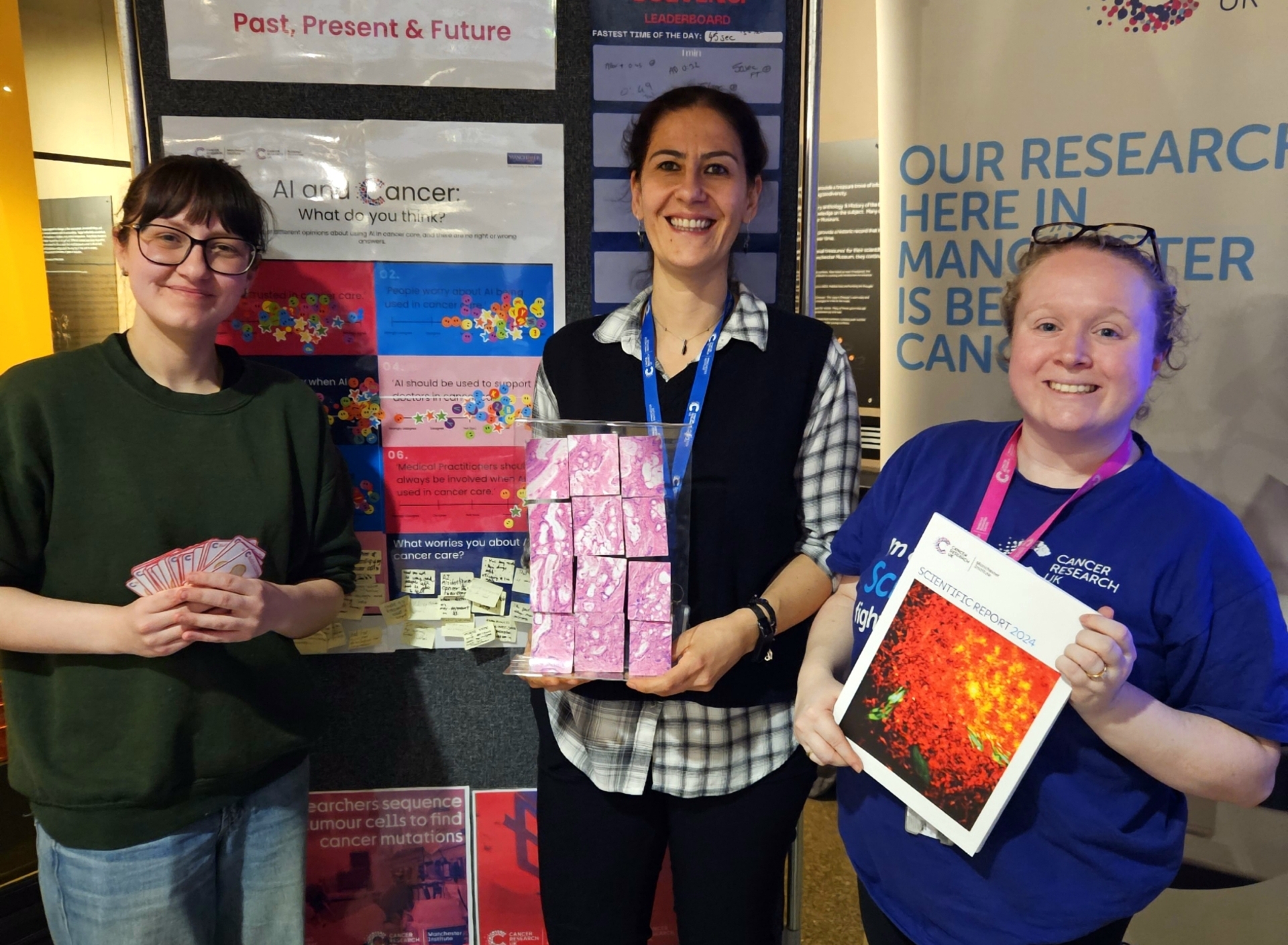 Holly Cassell (left), Arma Dogan Stewart (centre) and Hannah Sheedy (right) showcasing the cancer research stand at this year's British Science week.